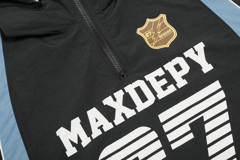 Black hooded half-zip nylon jersey with varsity-style MAXDEPY graphic and gold crest logo on the chest