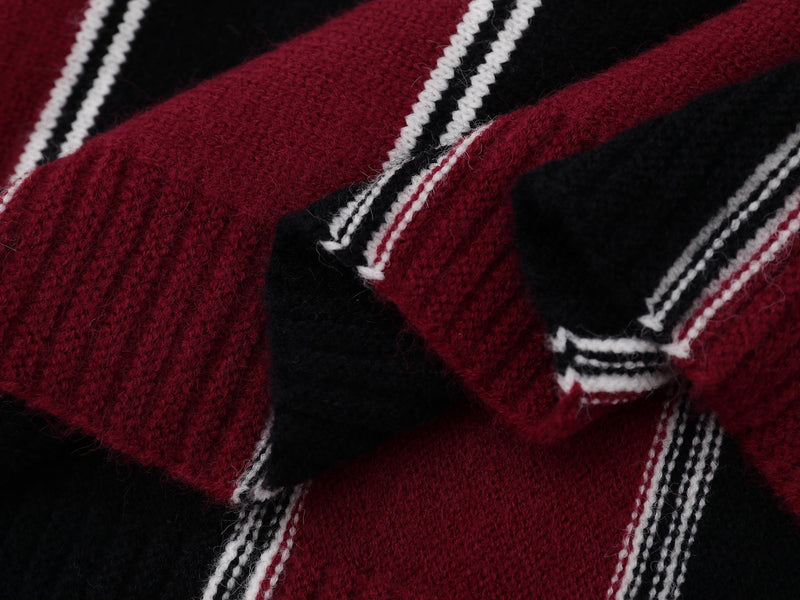 Close-up of burgundy and black knit fabric with white striped detailing
