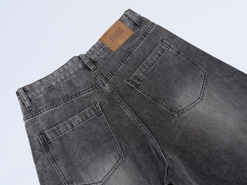 Back waistband of vintage grey denim jeans with brown JEANS label