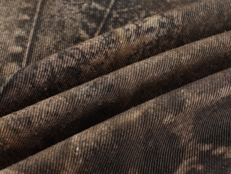 Close-up of textured brown animal print denim fabric folds