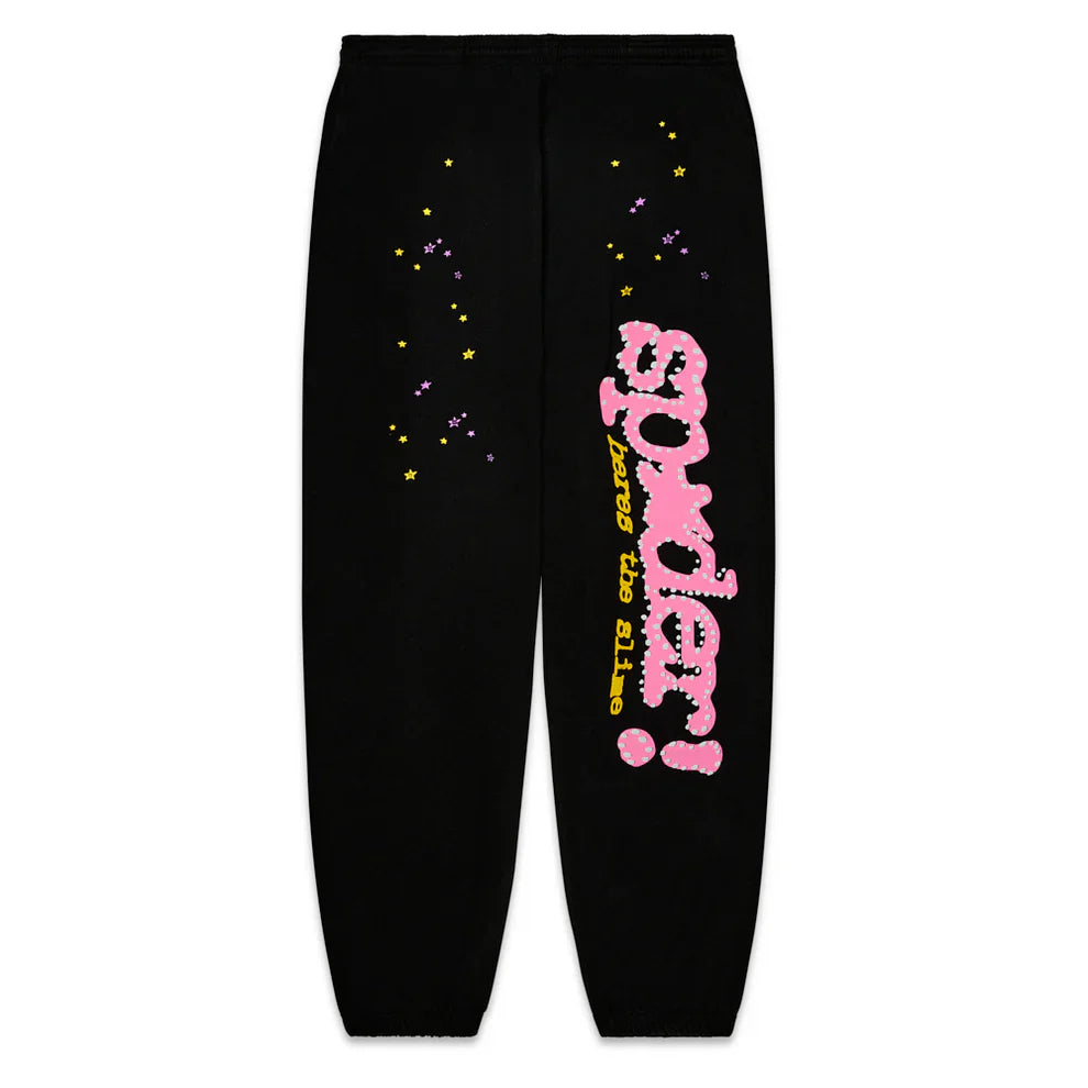 Sp5der Sweatpants – Unisex Black Cotton Sweatpants feature a pink graphic logo in a cloud-like font, yellow stars, purple dots, and "across the galaxy" text. Streetwear joggers with elastic cuffs for comfort and style.