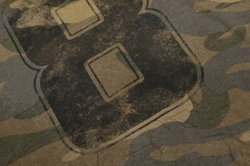 Close-up of faded number 8 print on camo tee with worn texture
