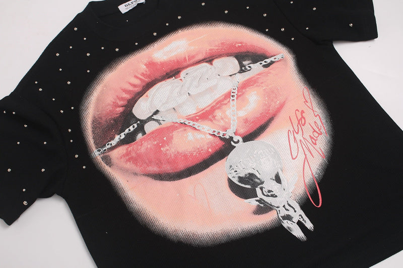 Black oversized T-shirt with rhinestone-studded lip graphic and chain detail in edgy Y2K streetwear style