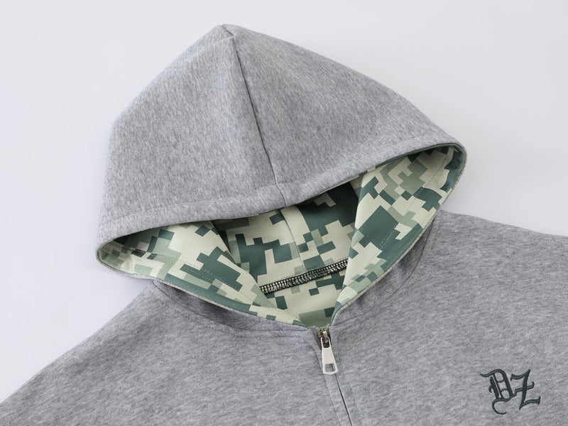 Close-up of gray hoodie hood with camouflage lining and zipper top