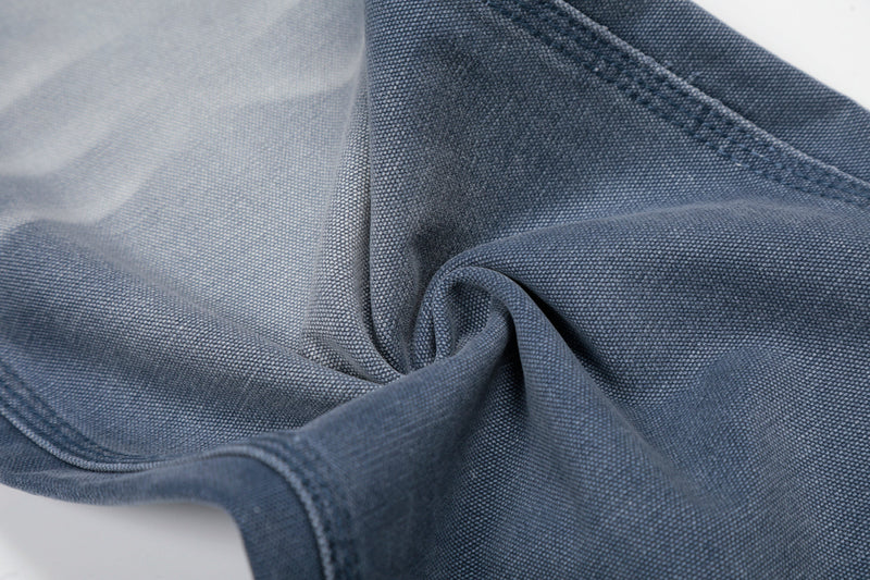 Close-up of gathered blue denim fabric showing texture and wrinkle effect
