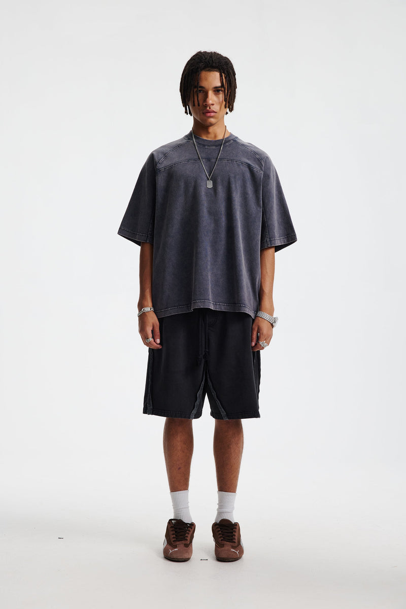 Vintage washed oversized charcoal cotton T-shirt with relaxed streetwear fit, worn by a model on a white background