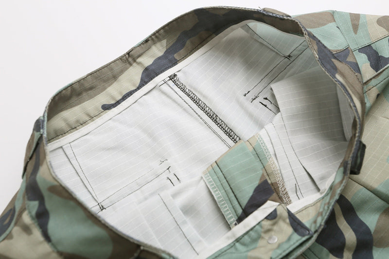 Inside waistband view of woodland camo cargo shorts with white lining