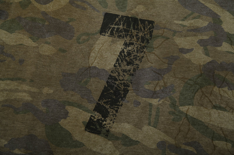 Close-up of large distressed number graphic on camo patchwork long sleeve tee