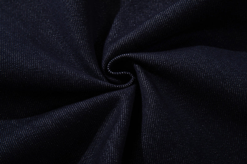 Close-up of dark wash denim fabric texture and weave