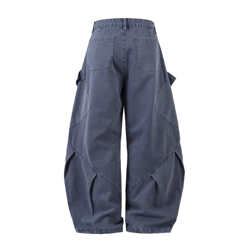 Back view of blue denim pants with patch pockets and wide curved barrel legs