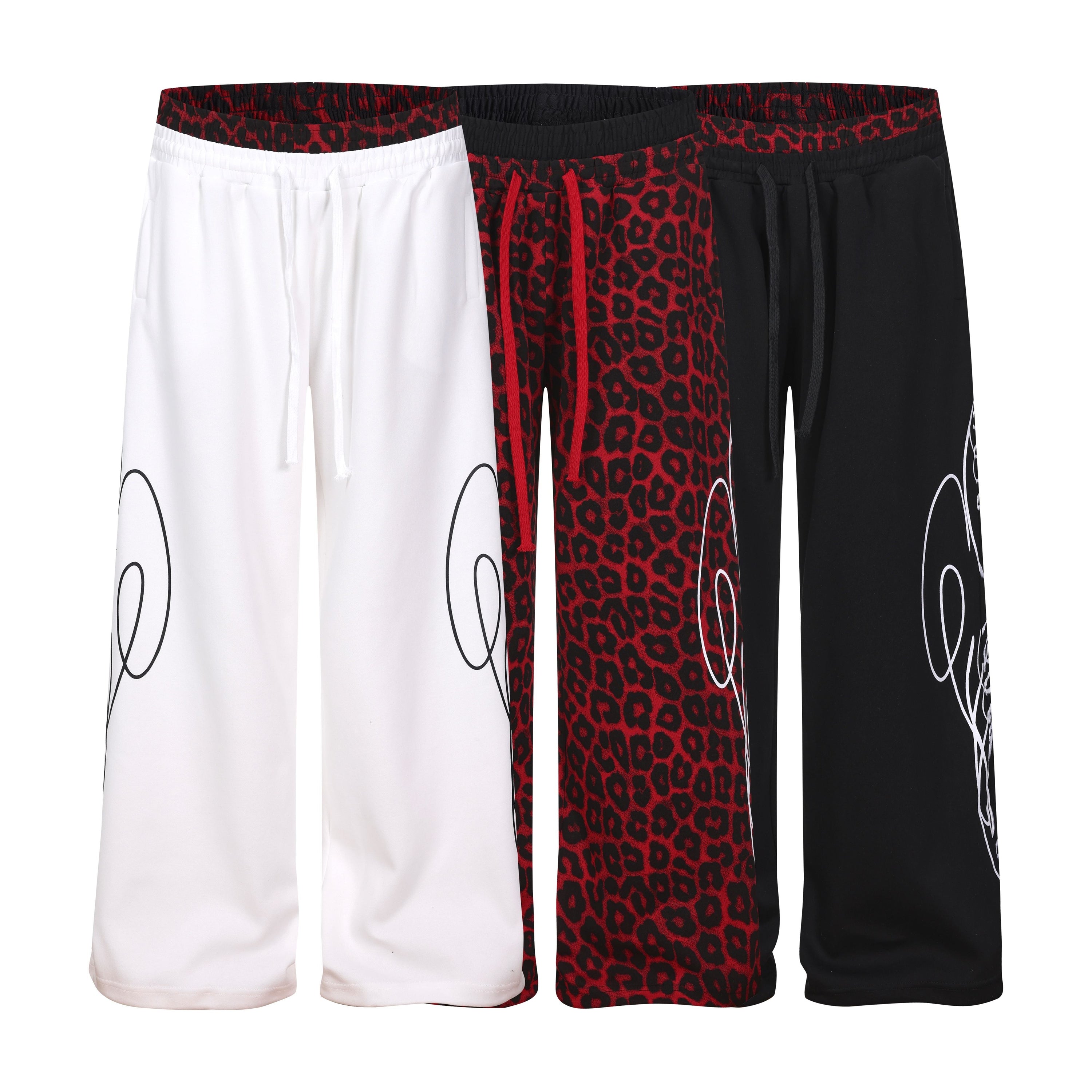 Three Omirad Leopard Panel Sweatpants displayed side by side in white, red leopard print, and black colorways with contrast w