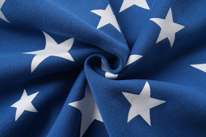 Close-up of blue star-print hoodie fabric gathered in folds
