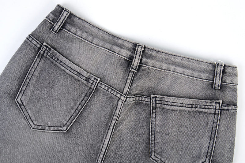 Back pocket area of grey wash jeans with contrast stitching and belt loops