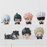 The Jujutsu Kaisen Chibi PVC 12-Piece Figure Set features adorable chibi anime figures with diverse hairstyles and expressions on clear stands, including one resembling a black cat. Perfect for fans, this collection includes vibrant hair colors like blue, green, and pink.