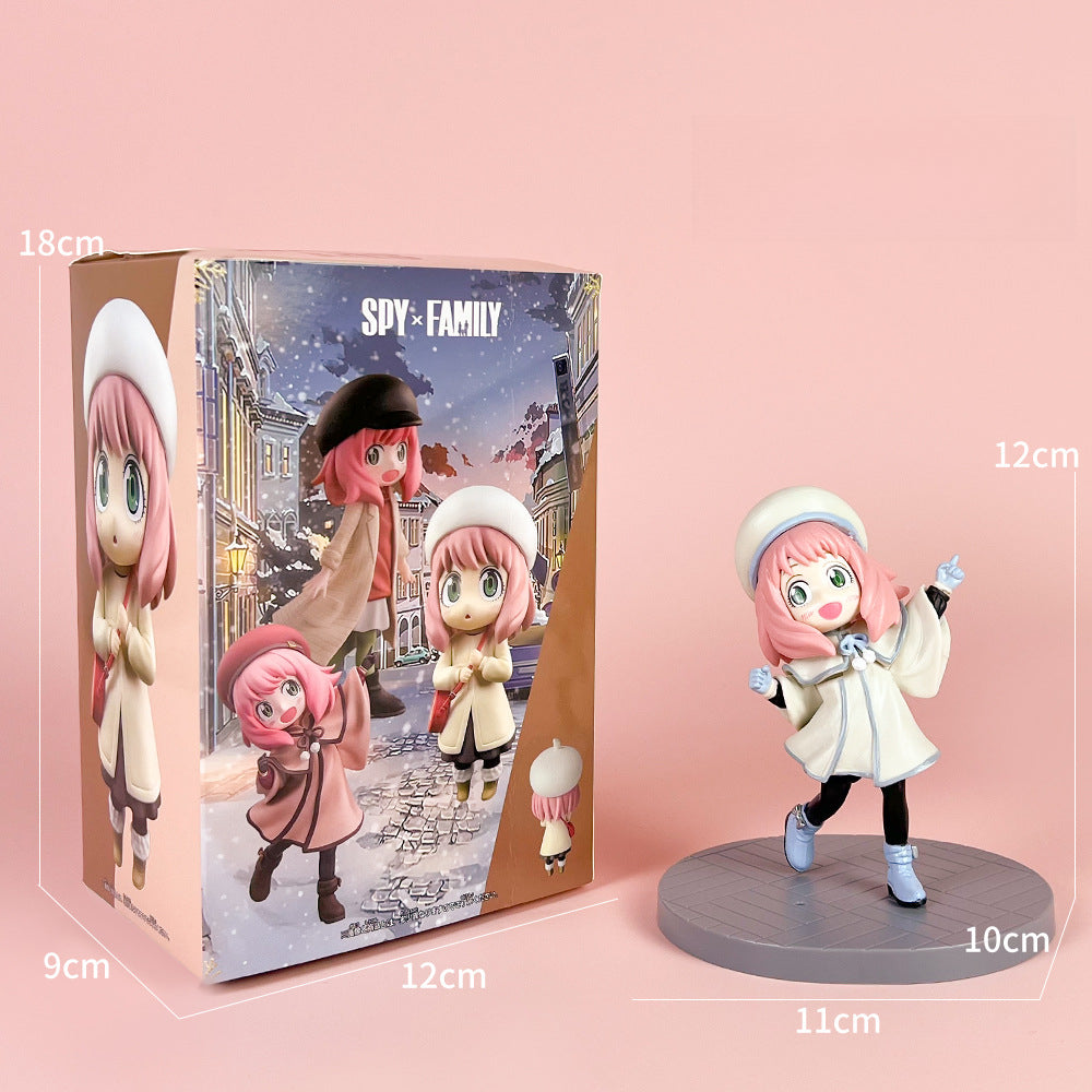 The Spy × Family Detective Anya PVC Figure Set presents a winter-themed, pink-haired character in 14 cm and 4 poses as part of the Movie Version series, featuring enchanting artwork and a standalone figure on a round base.