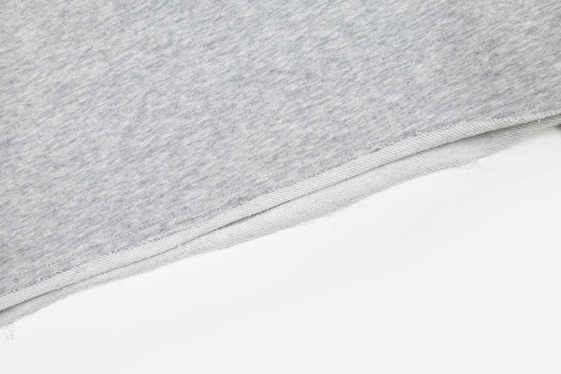 Close-up of heather gray shirt bottom hem with raw-edge stitching