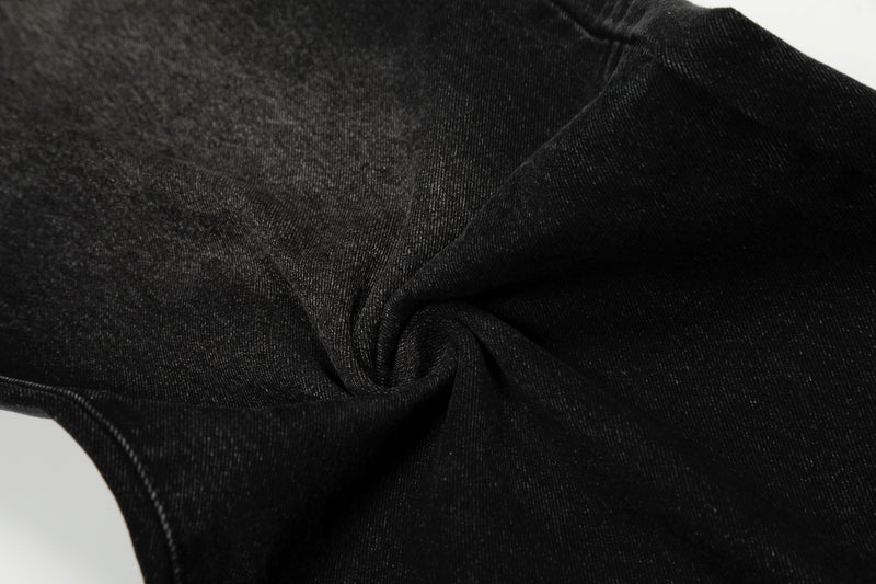 Close-up of black denim fabric texture and seam detail