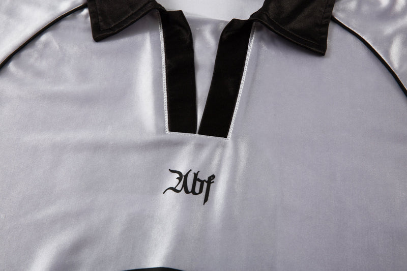 Close-up of white jersey chest and V-neck with black satin collar trim