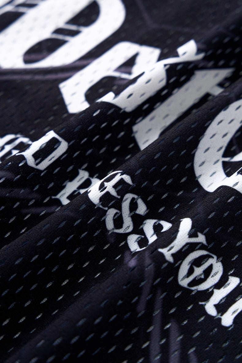 Black mesh soccer jersey with bold white gothic lettering and a textured streetwear print close-up