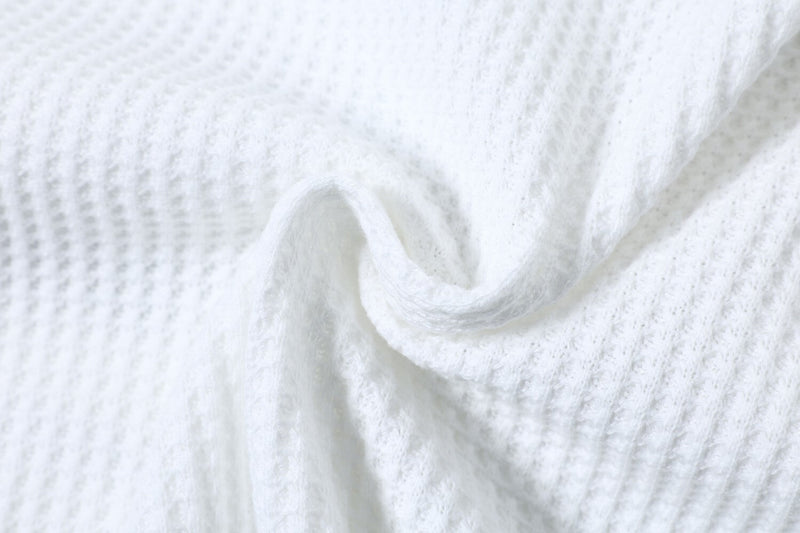 Close-up of gathered white waffle knit fabric texture