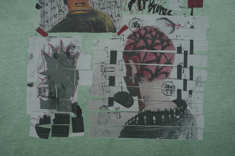 Vintage wash green graphic tee with layered collage street art print and abstract black, pink, and gray illustrations