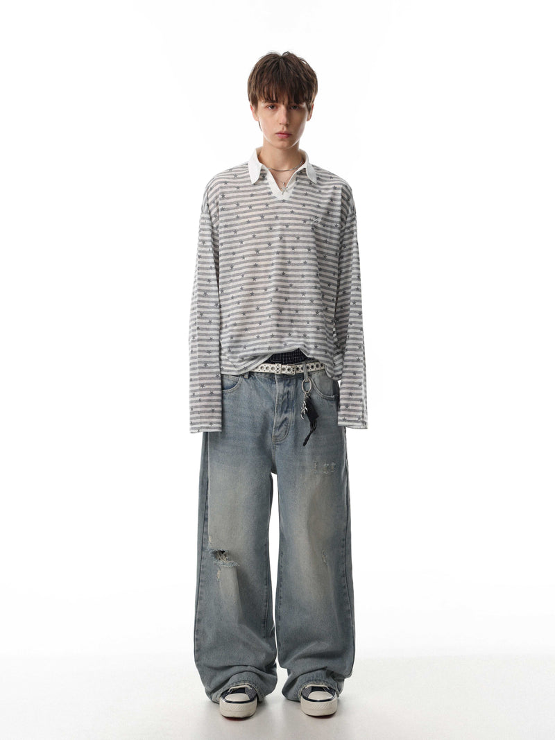 Gray striped star print long sleeve polo worn with loose-fit jeans, full-length front view