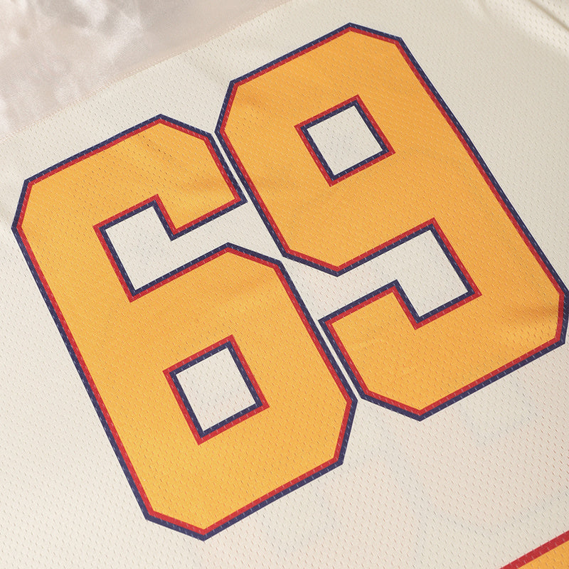 Close-up of a vintage white football jersey with large yellow number 69 outlined in red and blue