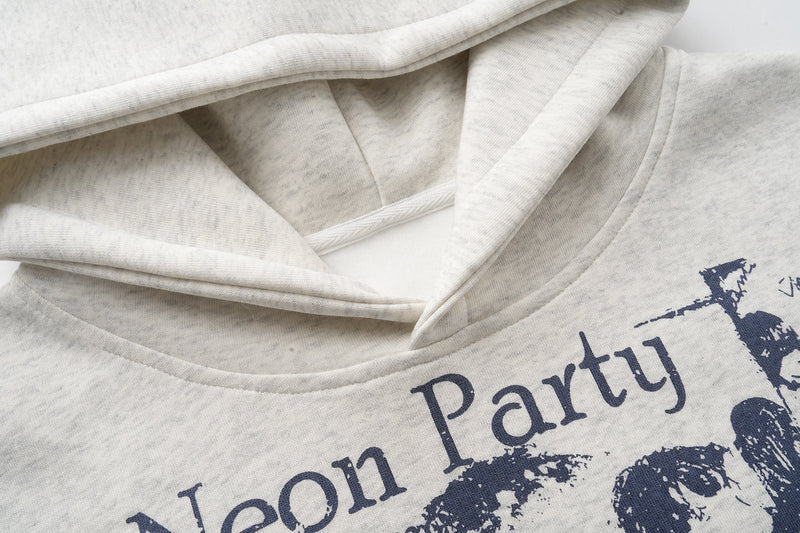 Close-up of hood opening and printed front graphic on light gray hoodie