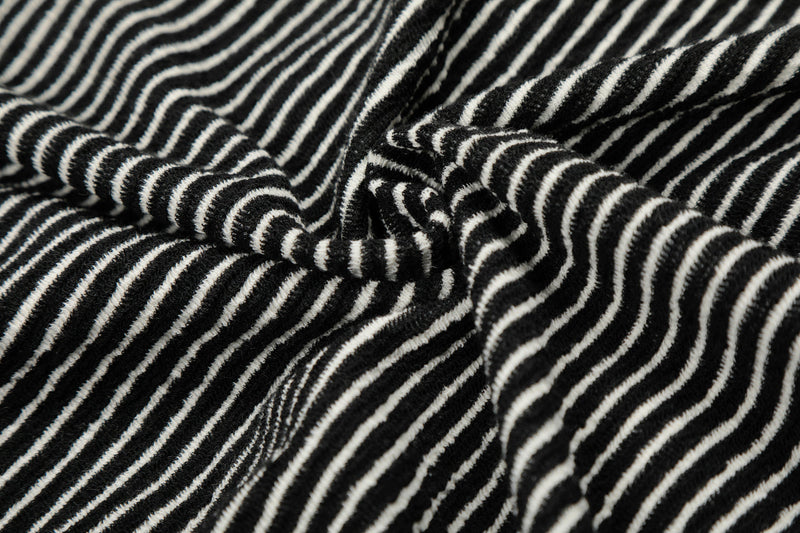 Close-up of gathered striped hoodie fabric at the hem