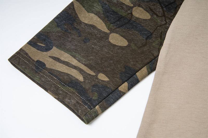 Close-up of camouflage long sleeve beneath beige short sleeve