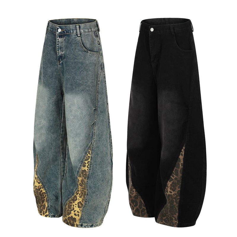 Front view of wide-leg blue and black denim jeans with leopard-print side panels