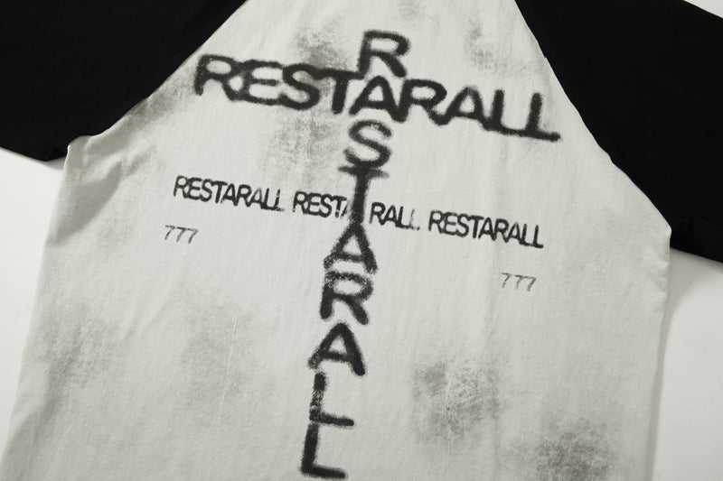 Distressed white raglan tee with black street-style graffiti print and worn underground aesthetic