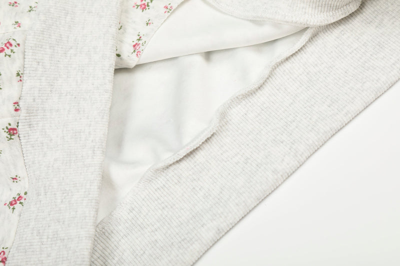 Close-up of hoodie interior lining and ribbed trim on cream floral fabric