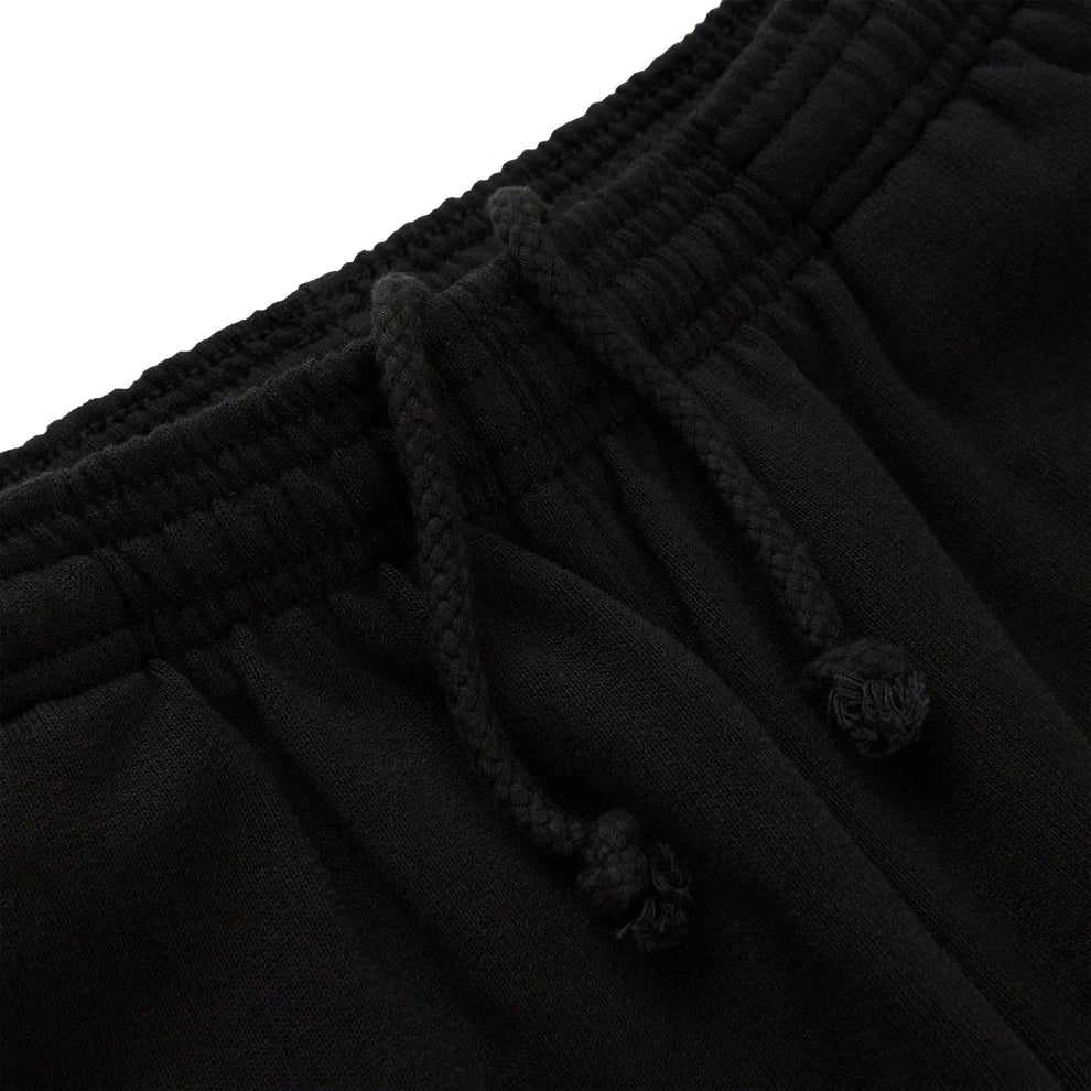 Close-up of the waistband of Sp5der Sweatpants – Unisex Black Cotton Sweatpants with Flame Front Logo Print, showcasing a textured elastic band and loosely tied black drawstrings for a classic streetwear jogger look.