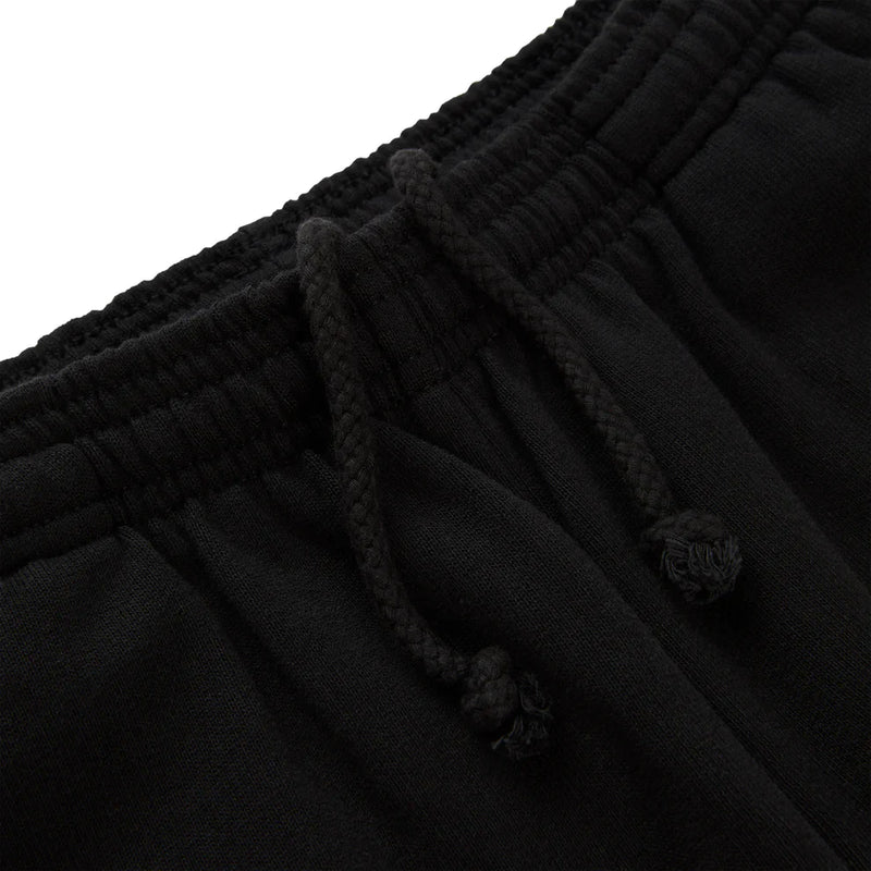 Close-up of the waistband of Sp5der Sweatpants – Unisex Black Cotton Sweatpants with Flame Front Logo Print, showcasing a textured elastic band and loosely tied black drawstrings for a classic streetwear jogger look.