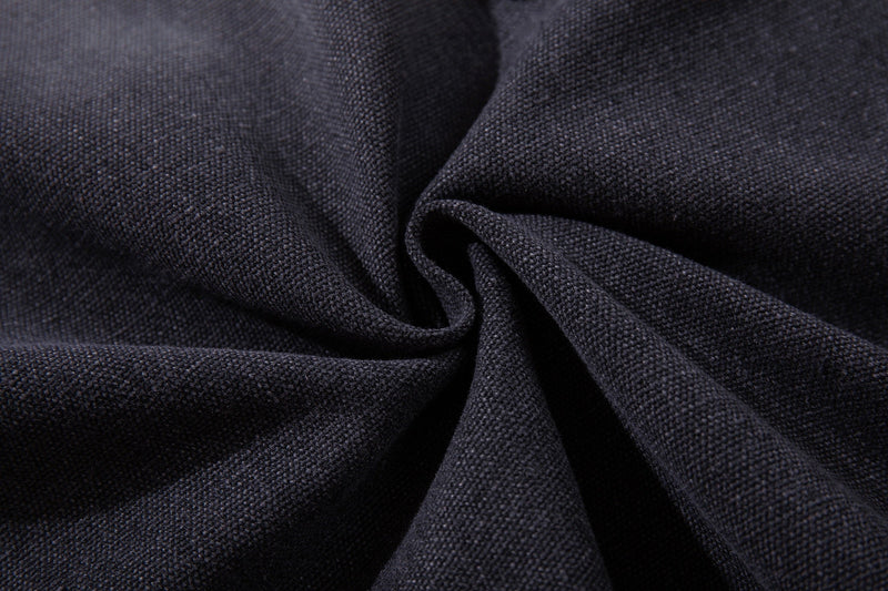 Close-up of dark denim fabric texture folded into a spiral