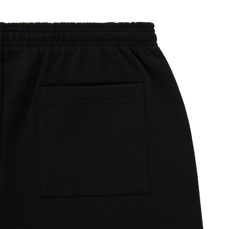 Close-up of Sp5der Sweatpants – Unisex Black Cotton Sweatpants with Flame Front Logo Print, featuring an elastic waistband and a single square hip pocket—a streetwear staple.