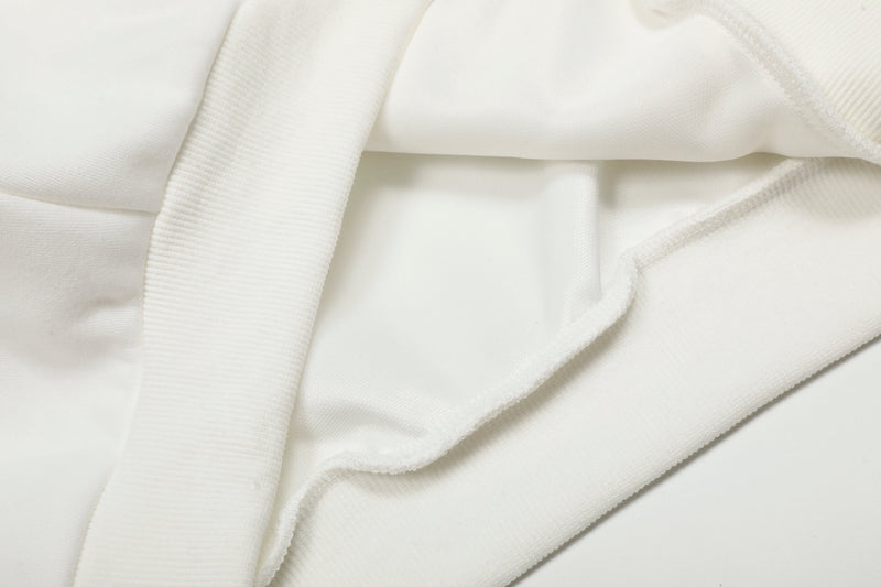 Close-up of white hoodie fabric and seam near the pocket