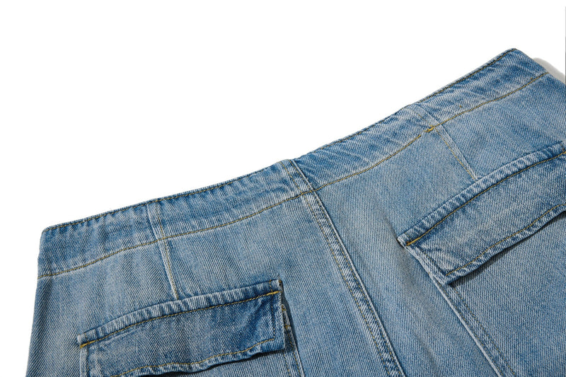 Close-up of jeans back pocket and upper yoke stitching in light wash denim