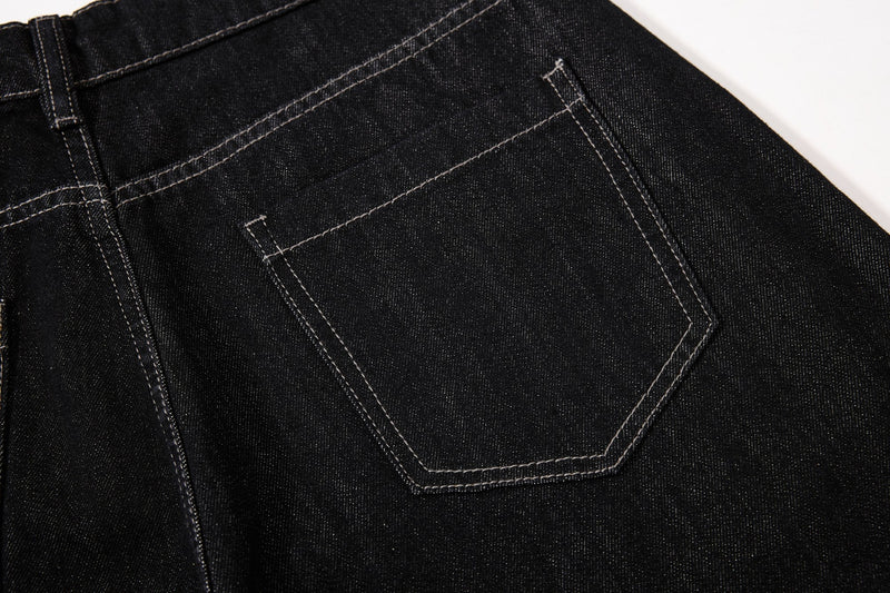 Close-up of back pocket stitching on black denim jeans