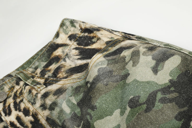 Close-up of side waistband on leopard camo cargo shorts with camo fabric and seam stitching