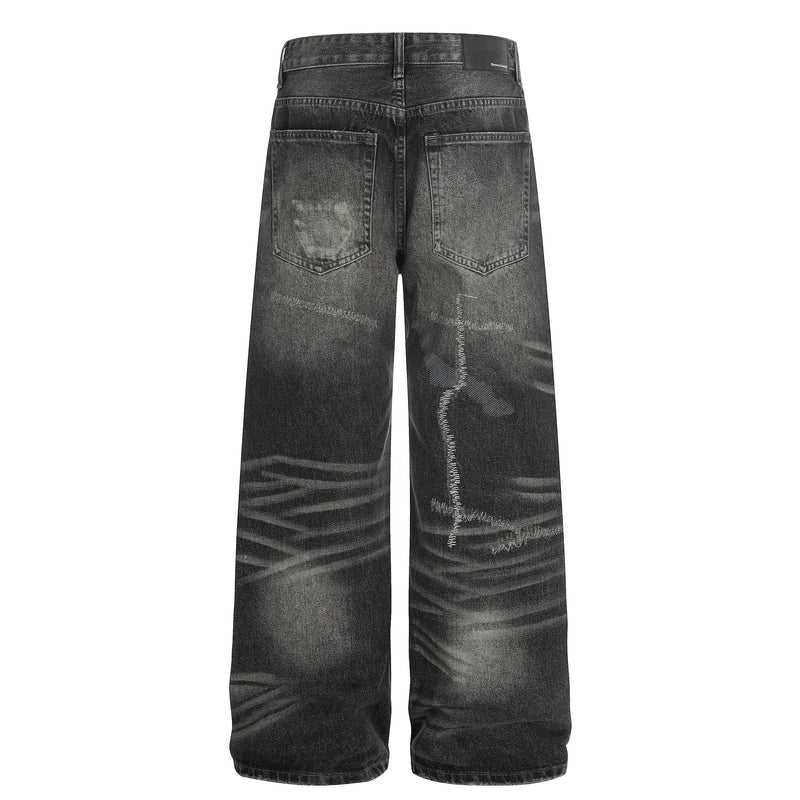 Back view of black washed wide-leg denim pants with distressed fading and patch pockets