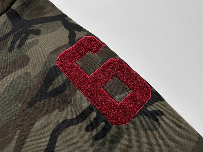 Close-up of red chenille 6 patch on camo hoodie sleeve