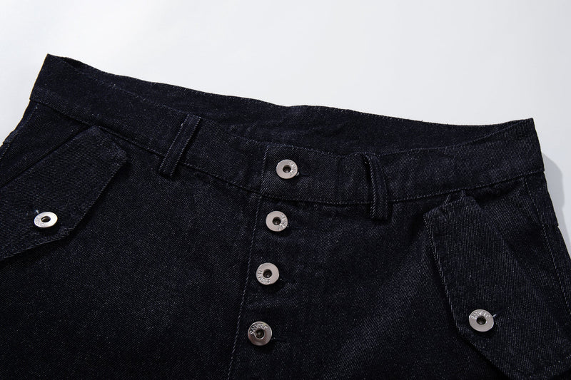 Close-up of the waistband and button fly on dark indigo denim pants