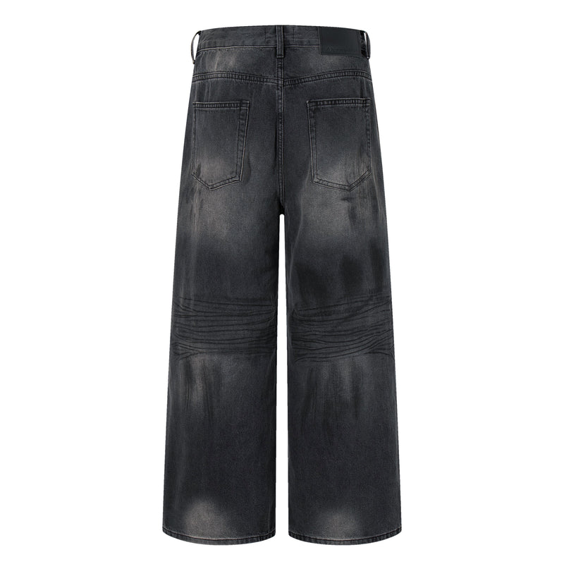 Back view of shadow wash wide-leg jeans with two patch pockets and faded denim finish