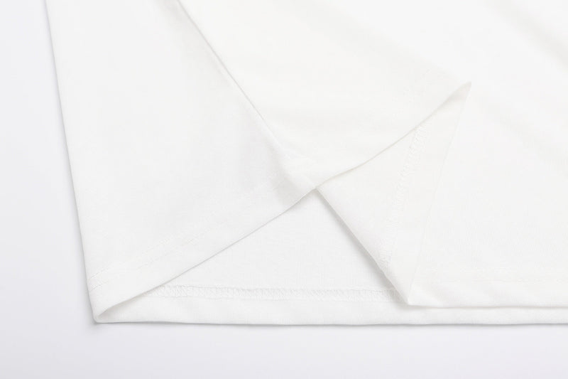 White vintage graphic T-shirt fabric close-up with soft folded hem and clean Y2K streetwear style