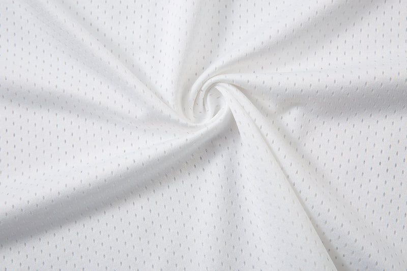 White mesh polo shirt fabric with subtle perforations and a close-up twisted texture for streetwear styling