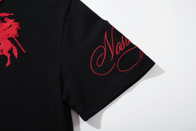 Black gothic polo tee with red embroidered script and oversized short sleeve detail on a white background