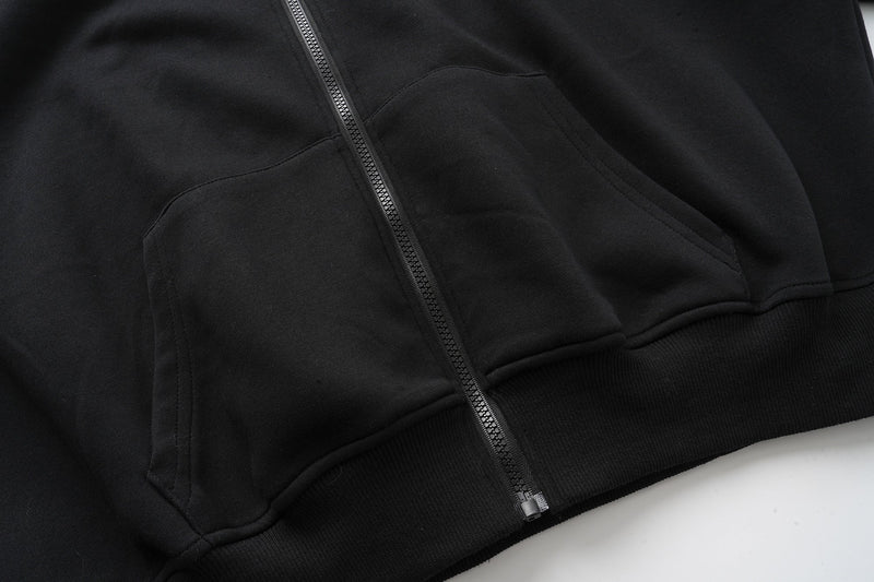 Close-up of black front pocket and zipper on the hoodie