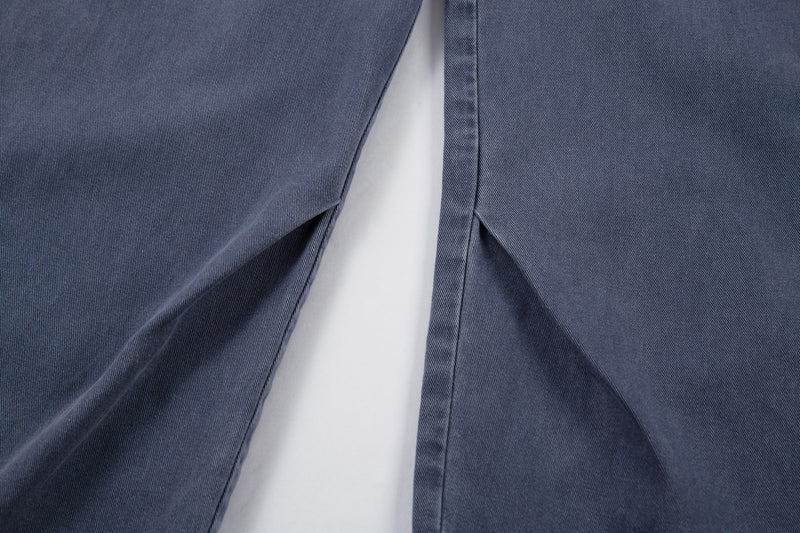 Front leg close-up showing wide fit and center inseam of blue denim pants